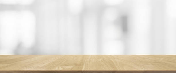 istock Wood table top and blurred abstract background from interior building banner background - can used for display or montage your products. 820829456