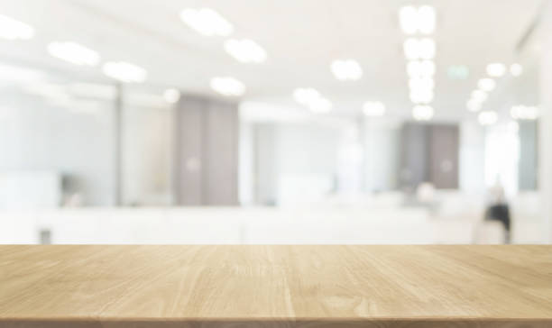 istock Wood table top and blurred bokeh office interior space background - can used for display or montage your products. 820829468