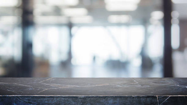 istock Black stone table top and blurred bokeh office interior space background - can used for display or montage your products. 820829484