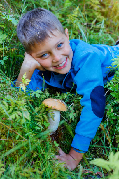 istock Boy with wild mushroom found in the forest 820829530