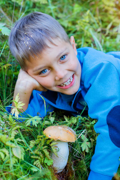 istock Boy with wild mushroom found in the forest 820829656