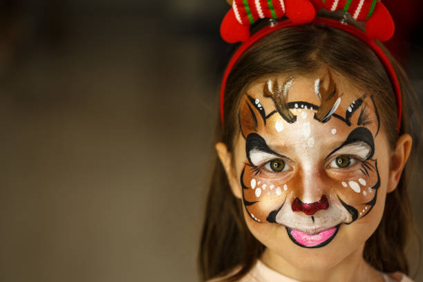 Little Reindeer Portrait of a cute little girl that has Reindeer painted on her face. rudolph the red nosed reindeer photos stock pictures, royalty-free photos & images