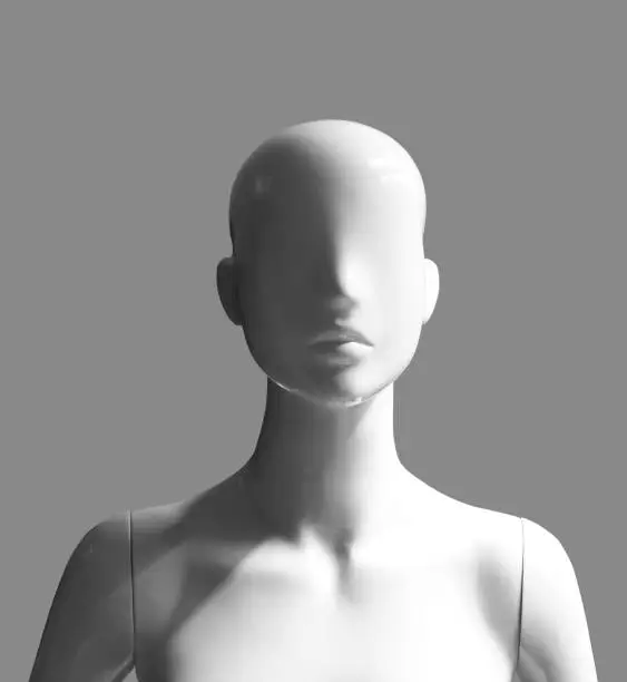 human female mannequin portrait photograph with light and shadow effects isolated on grey background