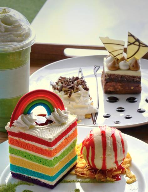 istock Piece of rectangular shape velvet rainbow cake with scoop of vanilla ice cream 820842438