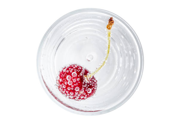 istock The red cherry and bubbles in sparkling soda water on white background, refreshment beverage. 820843310