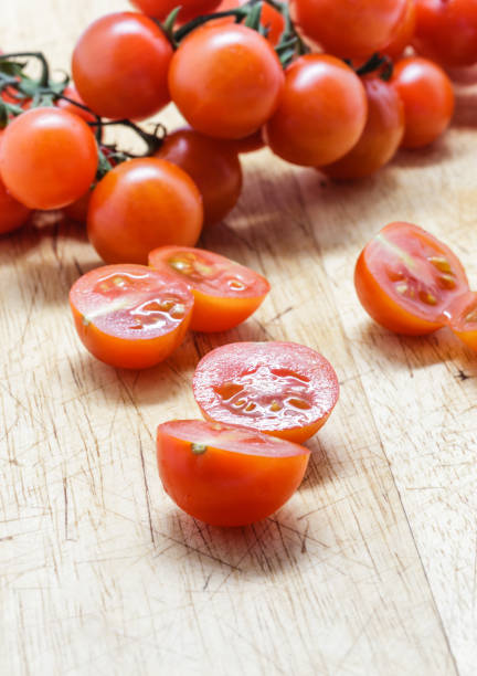 istock Cherry tomatoes on wooden cutting board. 820843586