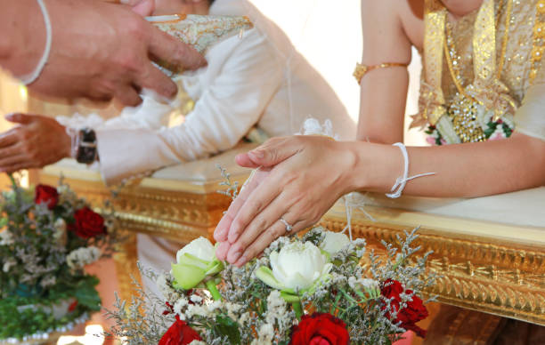 istock Hands pouring blessing water into bride's bands, Thai wedding. 820846298