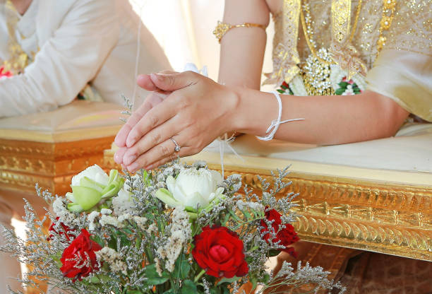 istock Hands pouring blessing water into bride's bands, Thai wedding. 820846342
