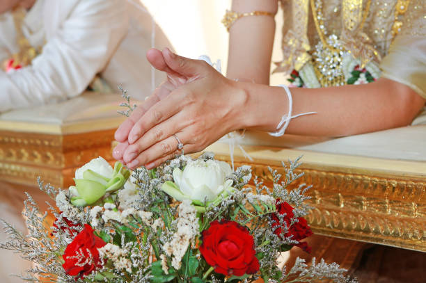istock Hands pouring blessing water into bride's bands, Thai wedding. 820846396