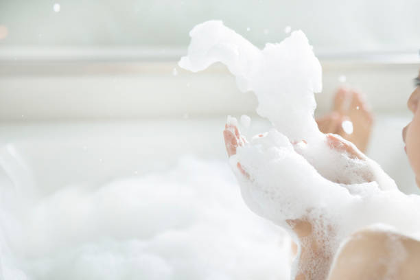 istock Women's feet she was bathing in a a bathtub with happiness 820847572