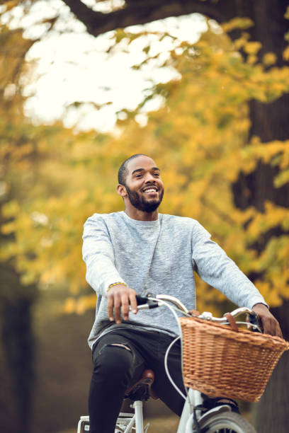 istock Happy black man enjoying while cycling in the park. 820848992