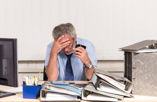 istock Businessman overstressed at his office desk 820850436