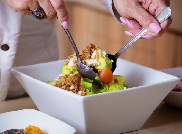 istock Healthy salad being mixed in a salad bowl 820852532