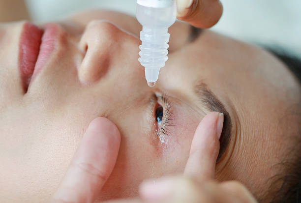 istock Closeup view of woman applying eye drop. 820854832