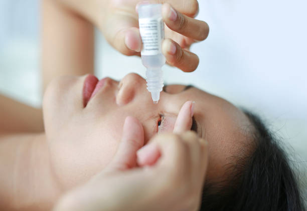 istock Closeup view of woman applying eye drop. 820854914
