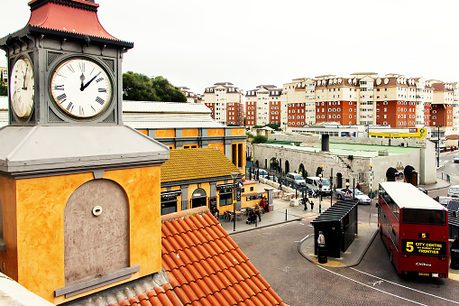 Gibraltar, Gibraltar - 13 november 2014: Top view of main bus station with  huge old clock in the foreground