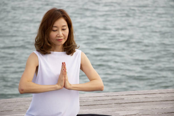 istock Woman is exercising yoga at seaside 820857920
