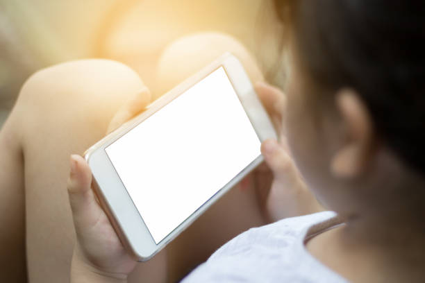 istock Asian kid girls are using a smartphone. 820857982