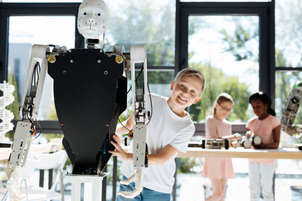 istock Cheerful little boy posing with a human robot 820858232