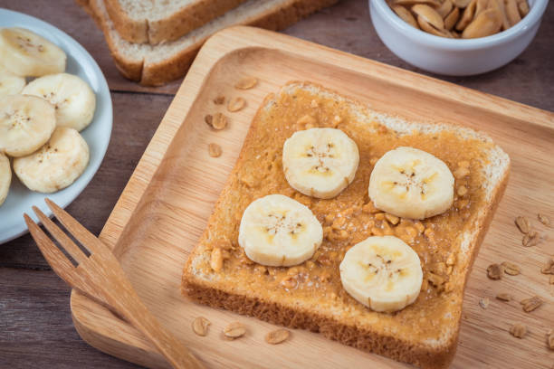 istock Bread with peanut butter and banana on plate 820858616