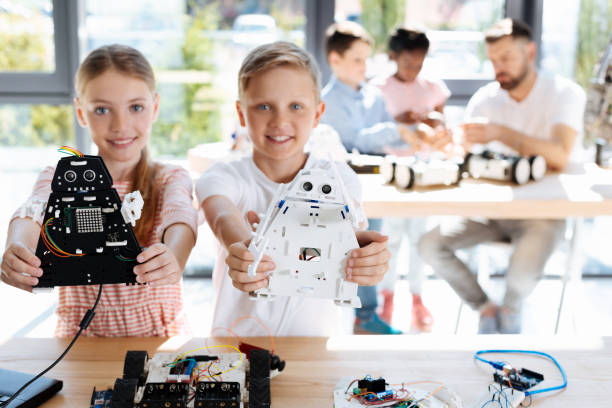 istock Brother and sister posing with robot models 820858954