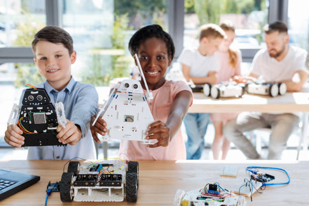istock Adorable girl and her friend posing with robot models 820859052