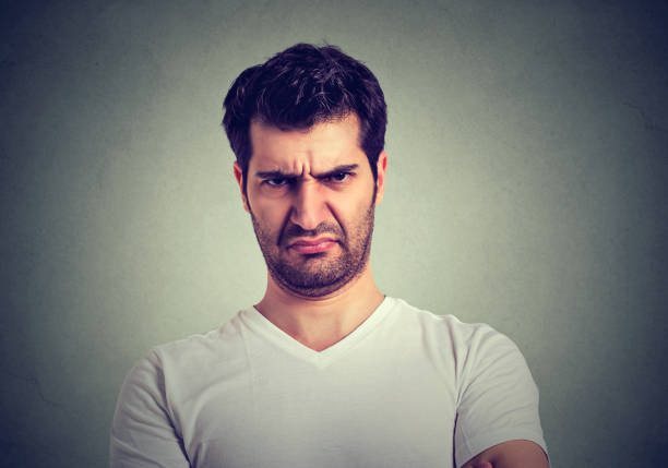 Middle-aged man scowls and shouts.