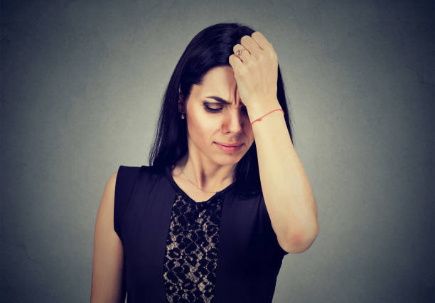 istock Sad regretful young woman looking down 820860062