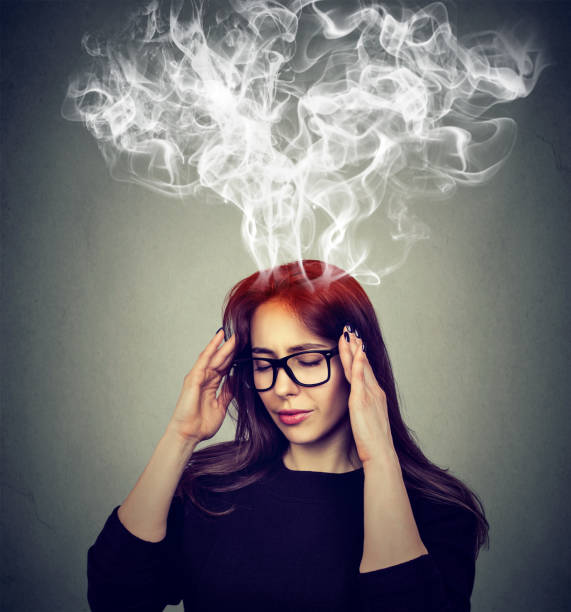 stressed woman thinking too hard steam coming out up of head - heat effort emotional stress business imagens e fotografias de stock