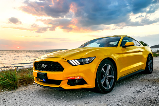 Campeche, Mexico - May 20, 2017: Yellow muscle car Ford Mustang at the countryside.