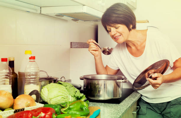 istock mature woman kitchen soup 820863666