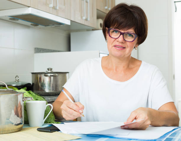 istock happy woman paying bills 820863728