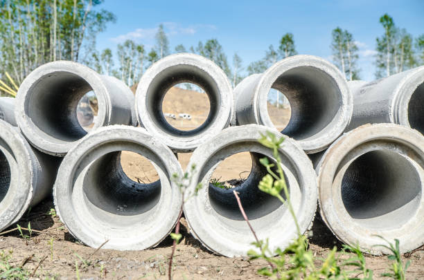 istock Construction site with concrete pipes in foreground during summer day 820866142