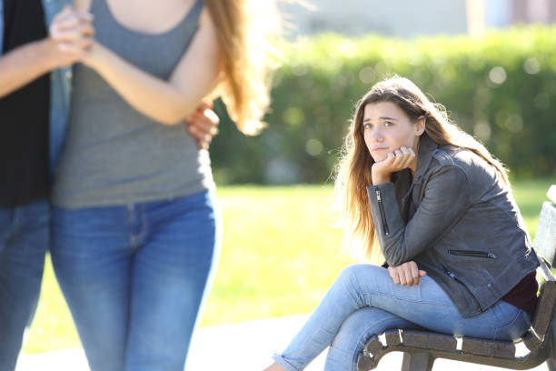 istock Sad girl looking at a couple walking 820868280