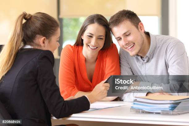 Seller Showing On Line Product To The Customers Stock Photo - Download Image Now - Customer, Bank - Financial Building, Real Estate Agent
