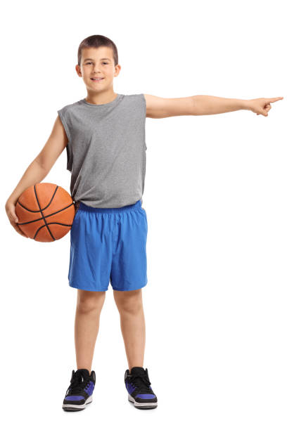 istock Boy with a basketball pointing right 820868964