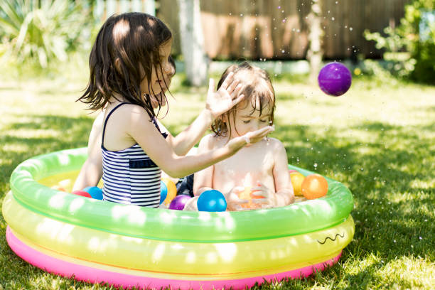 istock Cute children having fun in swimming pool 820873756