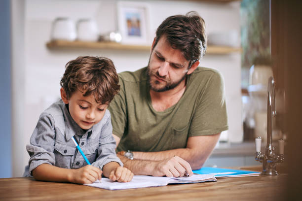 istock He takes an active interest in his son's schoolwork 820882924
