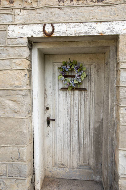 istock Rustic wooden door on stone wall 820886094