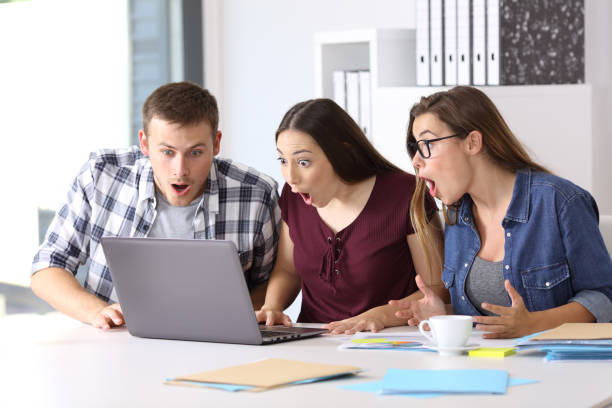 Three amazed entrepreneurs on line at office