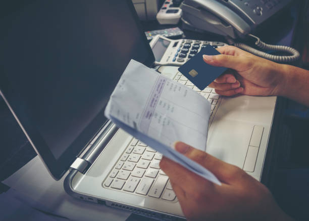 istock Hand of young man using credit card for paying bills on laptop 820893436