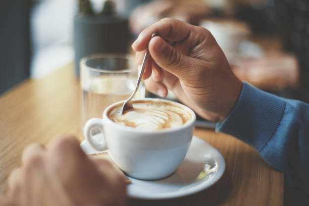 istock Young man drinking cappucinno in cafe 820896396