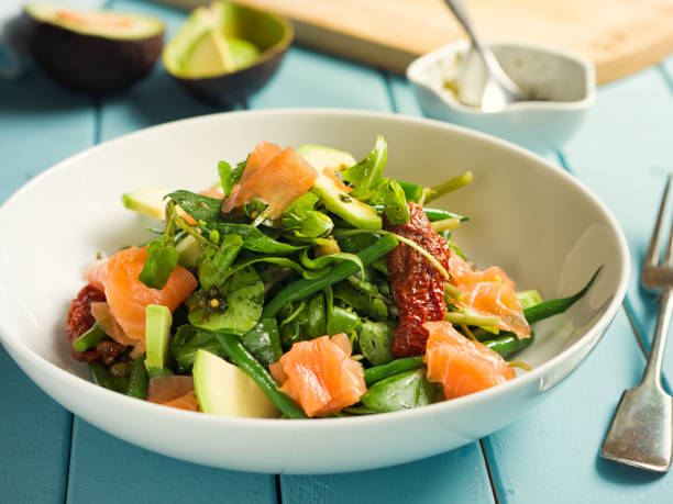 Healthy summer salad with smoke salmon Home made freshness green beans,watercress and sun dried tomatoes with smoke salmon and capers,avocado watercress stock pictures, royalty-free photos & images