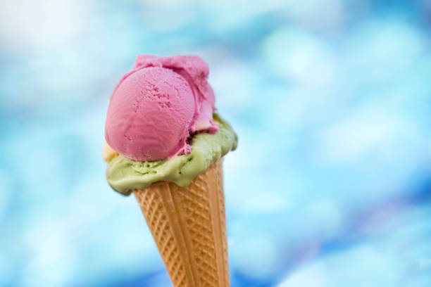 Strawberry and pistachio icecream cone stock photo