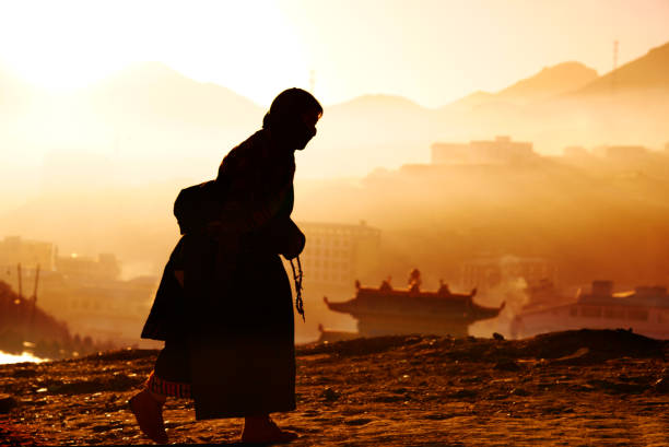 Langmusi, China - November 2015: Langmusi, Sichuan Province is the main temple of Tibetan Buddhism, a Tibetan woman standing in front of the temple.