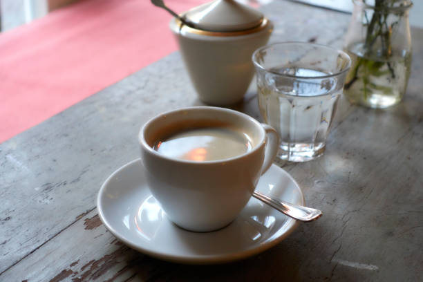 istock Cup of Black Coffee and Glass of Water on Rustic Table 820918920