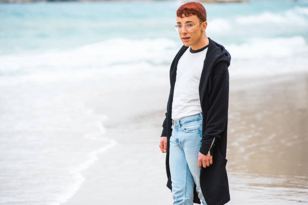 istock Young stylish weared gay is posing on a beach 820925976