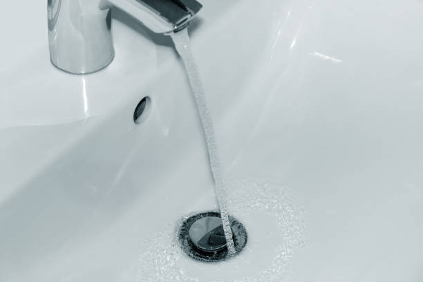 istock Flowing water from the tap into the washbasin 820933050