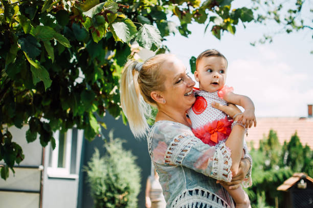 istock Mother with a baby in the yard 820933558
