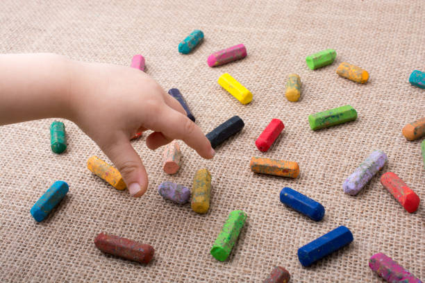 istock Used  color crayons and a toddlers hand 820950402